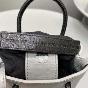 Mini Rose Red Balenciaga bag showcasing luxurious calf leather, iconic logo, and stylish design, highlighting craftsmanship and trendy appeal.