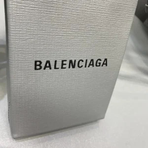 Balenciaga logo on a textured silver box, representing luxury packaging for the Mini Rose Red Balenciaga bag.