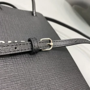 Close-up of the adjustable strap detail on a Mini Rose Red Balenciaga crossbody bag, showcasing luxurious calf leather texture and silver buckle hardware.