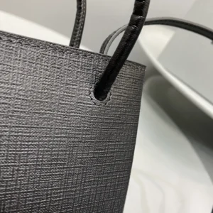 Close-up of the Mini Rose Red Balenciaga crossbody bag, showcasing its luxurious calf leather texture and sleek design details.