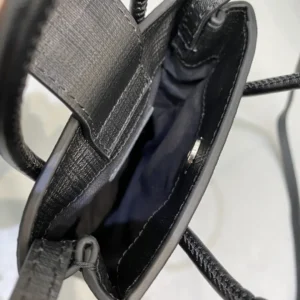 Interior view of Mini Rose Red Balenciaga crossbody bag showcasing luxurious calf leather, sleek design, and spacious compartment.