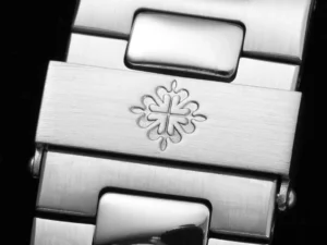 Patek Philippe watch clasp stainless steel with engraved Calatrava cross logo detail close-up