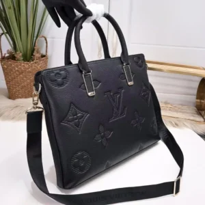 Black Louis Vuitton men's handbag with embossed logo and design, featuring dual handles and a detachable shoulder strap, displayed against a neutral background.