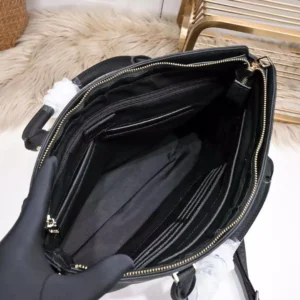 Interior view of a luxurious black LV Men's Handheld Bag, showcasing multiple compartments and a spacious design, emphasizing high-quality materials and craftsmanship.