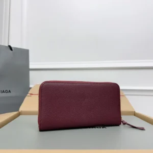 Balenciaga zip-around wallet burgundy leather with gold-tone zipper and pull tab accessory