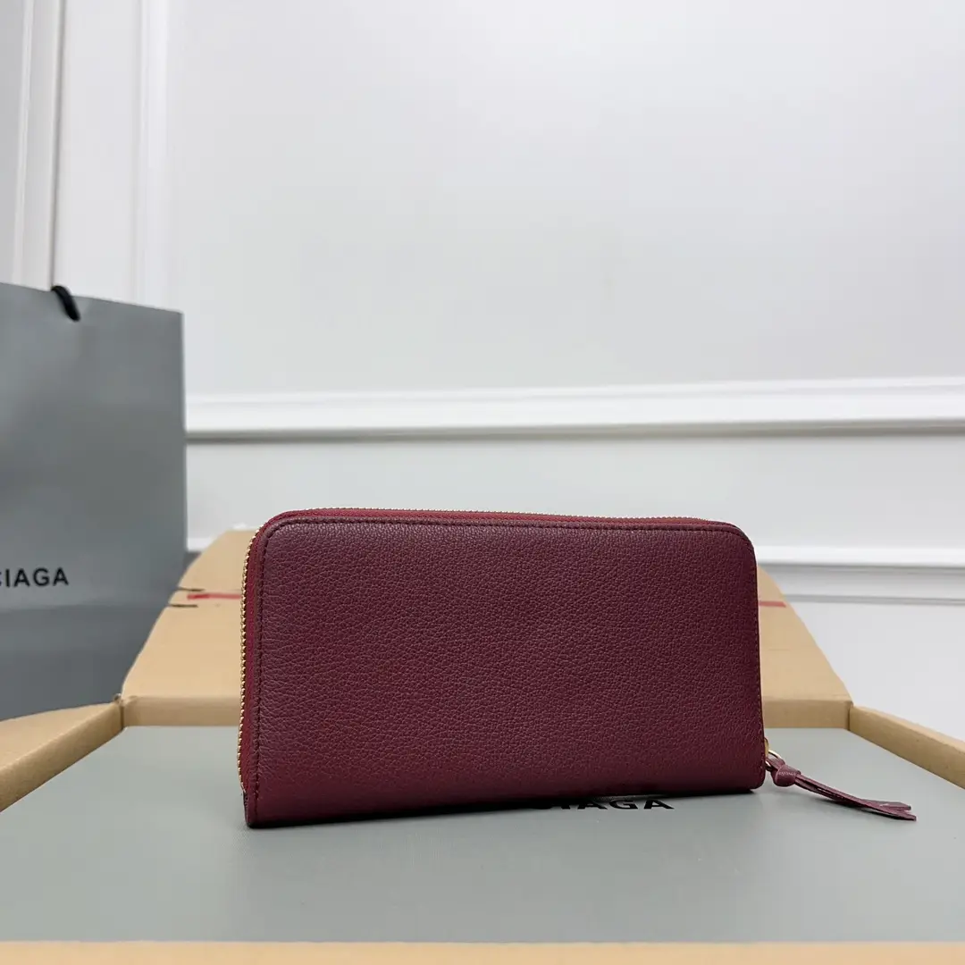 Balenciaga zip-around wallet burgundy leather with gold-tone zipper and pull tab accessory