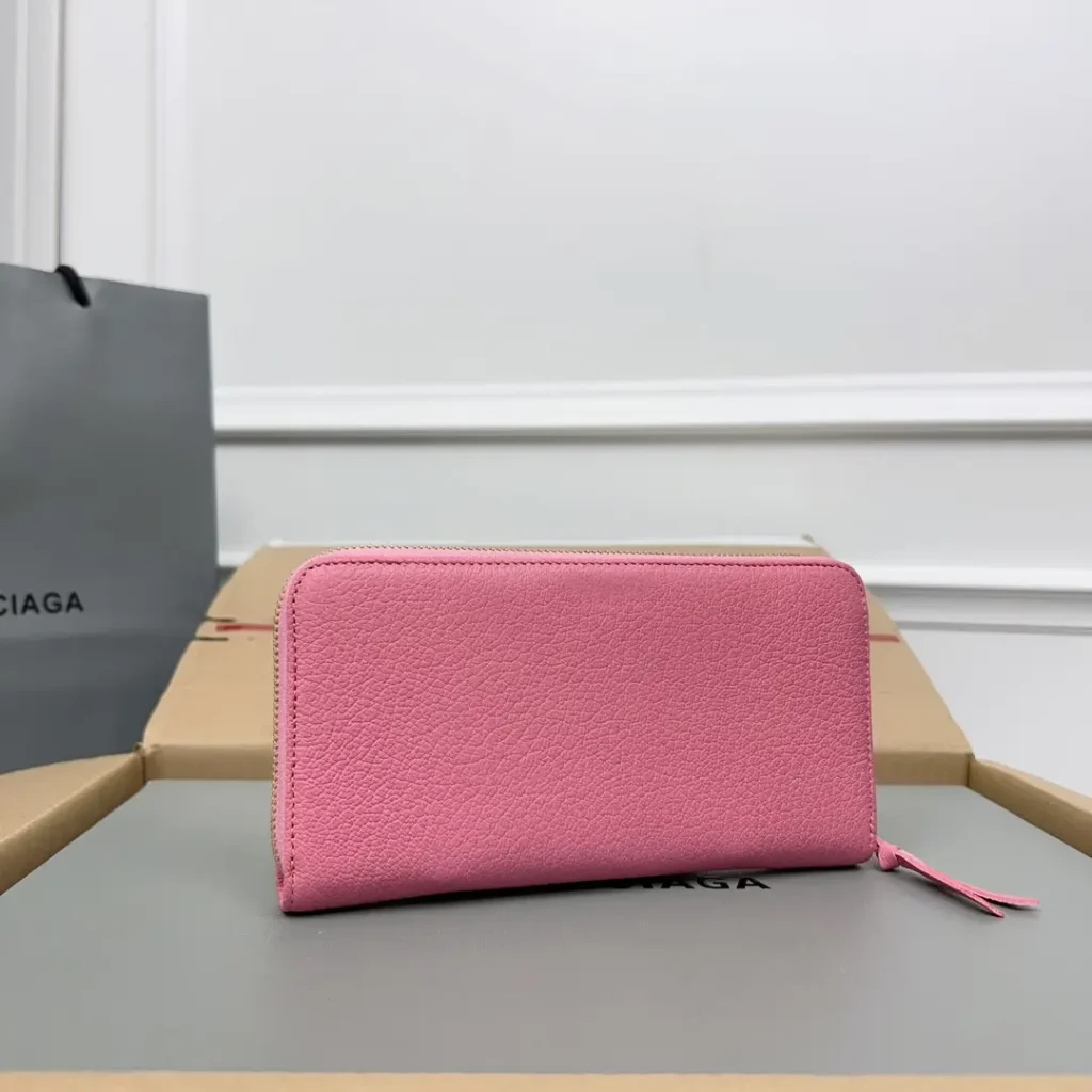 Balenciaga zip around wallet pink pebbled leather compact design with zipper closure