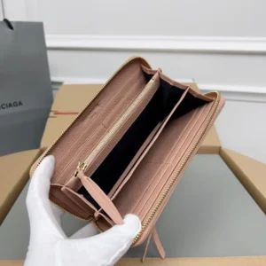 Balenciaga zip-around wallet pink leather multiple card slots and gold zipper interior compartments