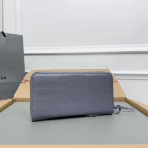 Balenciaga zip-around wallet light blue textured leather with leather pull tab accessory