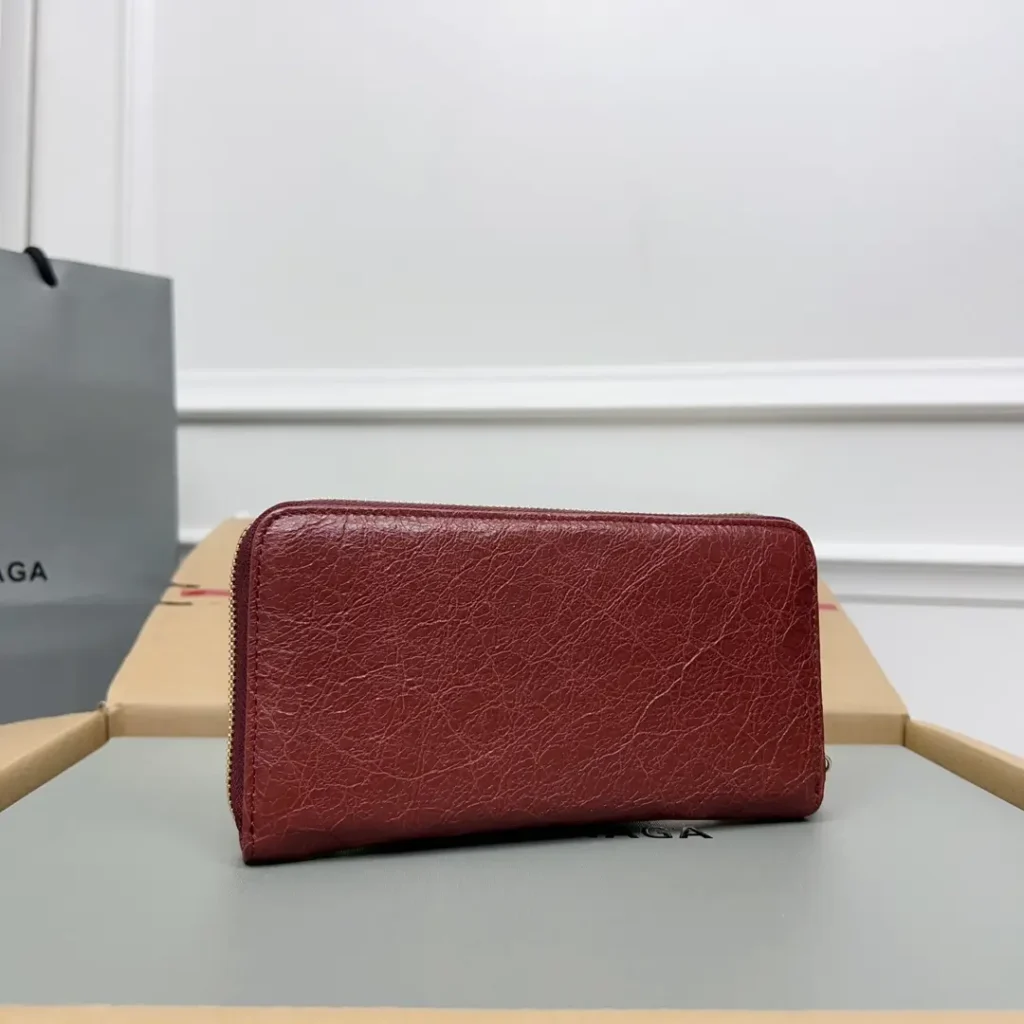 Balenciaga zip-around wallet red textured leather compact design with gold zipper hardware