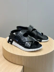 Unknown brand black cross strap sandals with textured leather upper and white black rubber sole