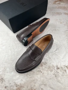 Dior Men’s Boutique Le Fu Shoes in dark brown leather with a sleek design, showcasing luxury craftsmanship and stylish urban appeal, positioned next to a black shoe box.