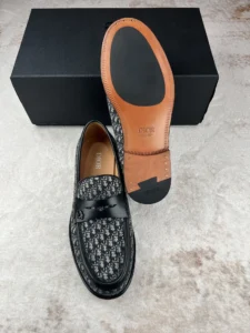 Dior Men's Boutique Le Fu Shoes featuring black and beige Oblique printed fabric, matte finish Dior logo, leather outsole, and elegant design, presented on a textured surface with a black shoe box.