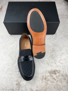 Dior Men's Boutique Le Fu Shoes featuring black Oblique printed fabric, leather outsole, and engraved Dior logo on the heel, presented with a black box background.
