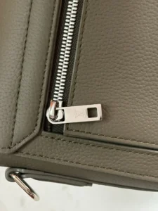 Louis Vuitton bag gray pebbled leather with silver zipper and monogrammed zipper pull detail