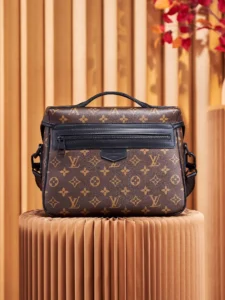 Louis Vuitton NFC Dynamic Chip Version LV Trail messenger bag featuring monogram macassar canvas, displayed on a textured pedestal with a neutral background.