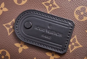 Louis Vuitton tag on monogram canvas, showcasing brand logo and craftsmanship details, relevant to NFC Dynamic Chip Version LV Trail messenger bag.