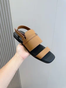 Hermes Oran sandal tan leather black sole flat sandal with silver H buckle detail