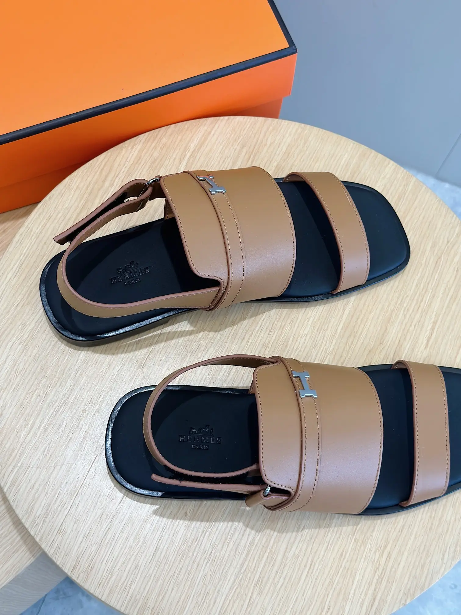 Hermes sandals brown leather straps black sole slip-on sandals with silver H logo detail