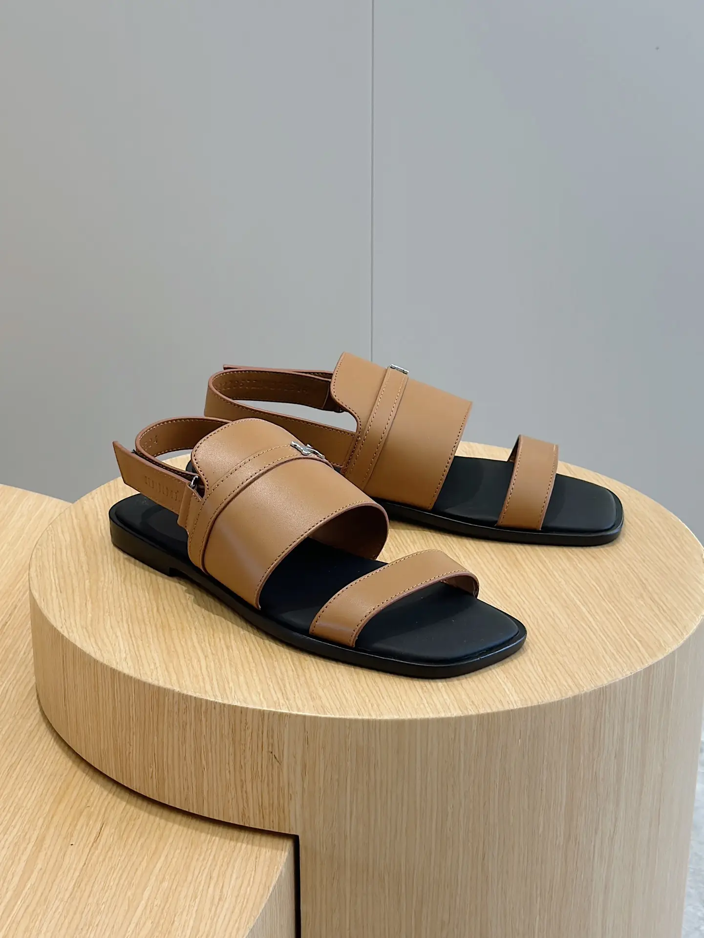 Hermes Oran sandals tan leather black sole flat open-toe slingback sandals