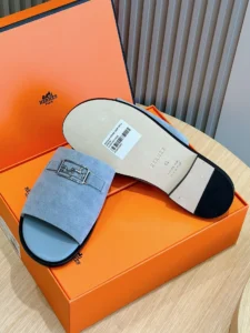 Men's genuine leather sandals with palladium-plated buckles, displayed on an orange box, highlighting premium craftsmanship and comfort.