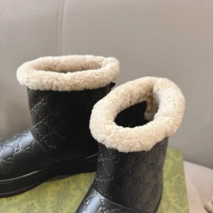 Gucci leather winter boots black shearling lining embossed GG pattern warm ankle boots