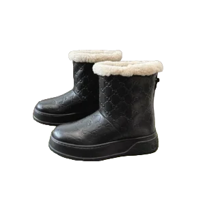 Gucci shearling-lined ankle boots black leather embossed GG pattern winter footwear