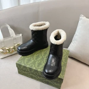 Gucci ankle boots black leather with embossed GG logo and white shearling lining winter footwear