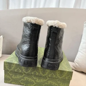 Gucci leather boots black embossed GG pattern shearling lining winter footwear