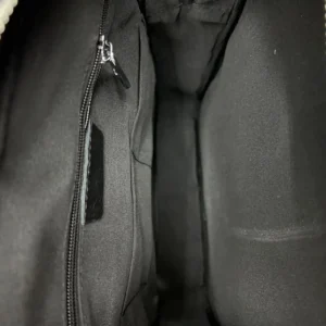 Chanel Classic Flap Medium black leather handbag interior with zip pocket and fabric lining