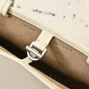 Close-up of the interior of The Row Park tote, featuring a soft leather lining, strap buckle, and minimalist design elements, highlighting its premium craftsmanship and utility.