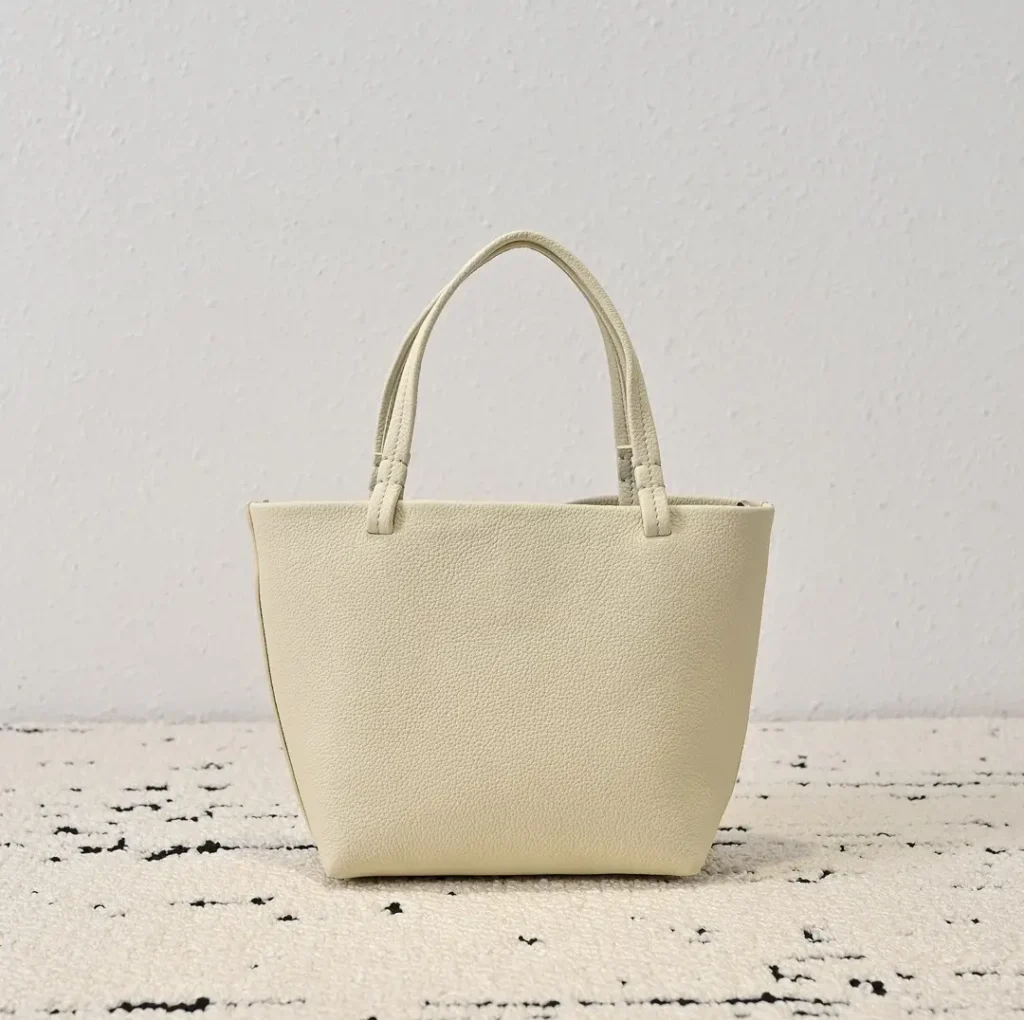 Generic brand leather tote bag small beige color textured leather material handbag