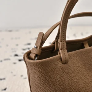 Close-up of The Row Park tote bag featuring textured lychee patterned cowhide, highlighting the soft leather handles and minimalist design, suitable for fashion-conscious consumers.