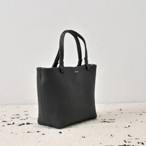 The Row Park tote bag in black leather with dual handles, showcasing a sleek design and soft texture, ideal for stylish carrying options.