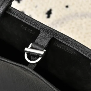 The Row Park tote interior showing leather texture, silver hardware, and "MADE IN ITALY" embossed detail.