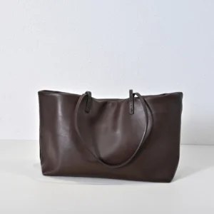 Therow Nuance Sheepskin Tote Bag in dark brown leather, minimalist design with soft lambskin material and two handles, showcased on a light background.