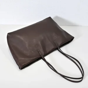 Therow Nuance Sheepskin Tote Bag in dark brown, featuring minimalist design, soft lambskin material, and long shoulder straps.
