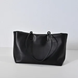 Therow Nuance Sheepskin Tote Bag in black leather, showcasing minimalist design and soft texture, emphasizing luxury and functionality.