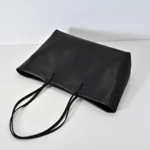 Therow Nuance Sheepskin Tote Bag in minimalist black leather with dual handles, showcasing a sleek and understated design.