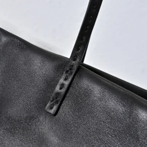 Close-up of Therow Nuance Sheepskin Tote Bag strap and textured leather, emphasizing minimalist design and luxury material.