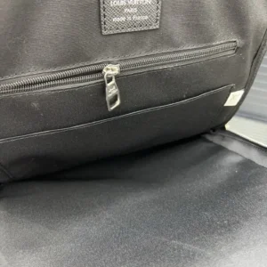 Louis Vuitton printed backpack interior featuring zipper pocket and brand label, highlighting craftsmanship and quality of replica designer products.