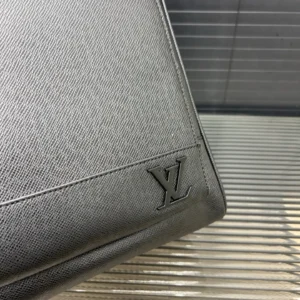 Louis Vuitton printed backpack featuring embossed logo on textured material, showcasing luxury craftsmanship and design.