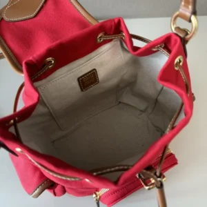 Interior view of MIU New College Style Backpack, featuring a red fabric lining, leather accents, and spacious compartment.
