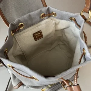 Interior view of MIU MIU New College Style Backpack showcasing spacious design, durable linen blend lining, and logo tag.