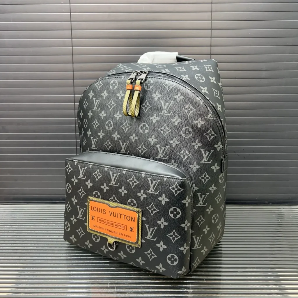 Louis Vuitton Christopher PM backpack monogram canvas black with orange leather patch and zipper pulls