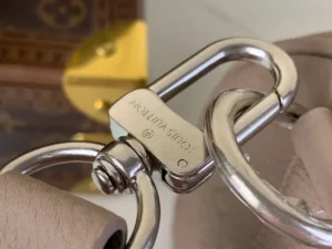 Louis Vuitton bag hardware silver metal clasp detail with beige leather handle close-up