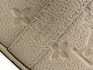 Louis Vuitton bag beige leather textured monogram embossed luxury design craftsmanship detail close-up