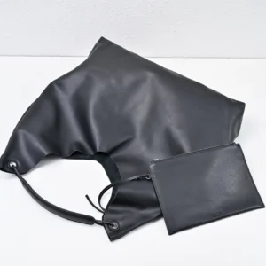 The Row Ascot small black leather bag with removable pouch and relaxed silhouette