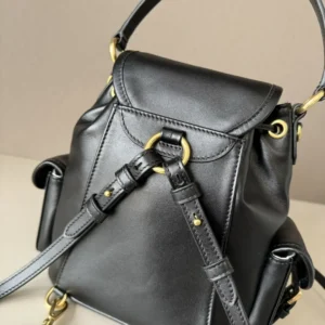 MIU New College Style Backpack in black leather with gold hardware, featuring a multi-pocket design and adjustable straps, ideal for casual outfits.