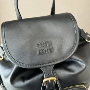 Miu Miu backpack small black smooth leather bag with gold buckle and front zipper pocket